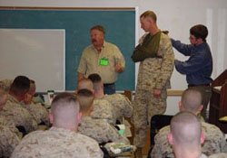 Wilderness First Responder student assisting Carl Weil, WMO's Director, doing Heavy Trauma Training for Marines on their way to Iraq